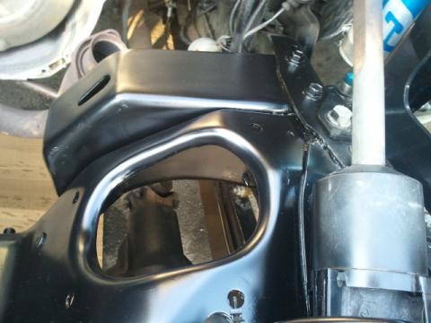 1986 Ford Bronco - Undercarriage view of vehicle frame and suspension components, with Supermotors.net logo.