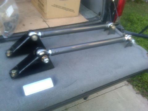1986 Ford Bronco - Aftermarket suspension parts are visible inside the cargo area of a vehicle.
