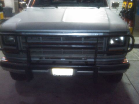1986 Ford Bronco - Front view of a gray Ford Bronco with a black bull bar and a license plate.