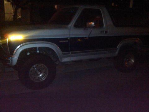 1986 Ford Bronco - This 1986 Ford Bronco is shown from the side at night.