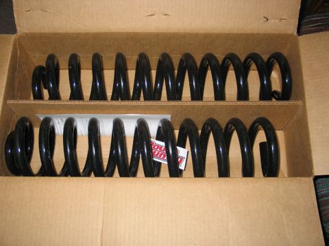 1995 Ford Bronco - New Rough Country coil springs are packaged in a cardboard box, ready for installation.