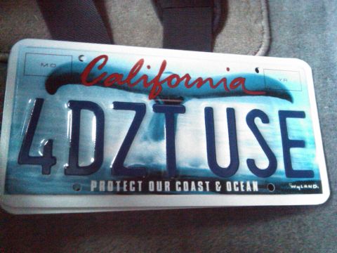 1986 Ford Bronco - A California license plate with a whale tail graphic and the phrase 'Protect Our Coast & Ocean' is shown.