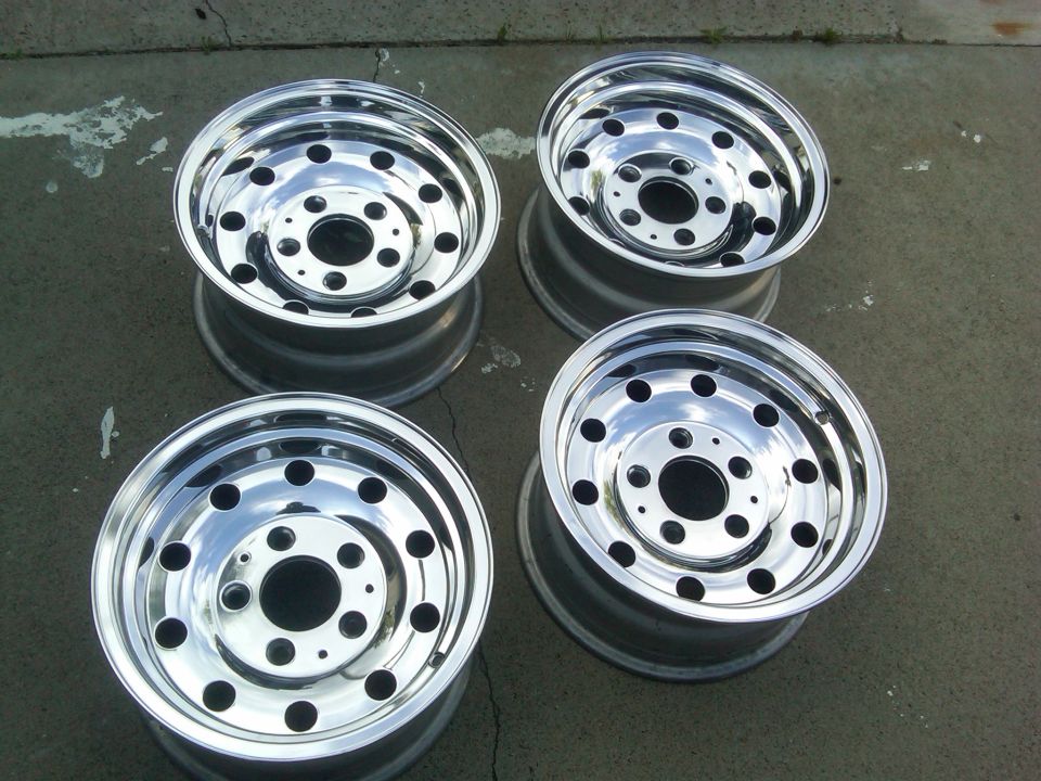 four chrome wheels with multiple bolt holes