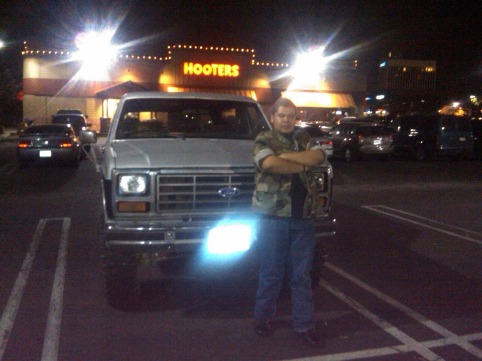 1986 Ford Bronco front view parked at night with Hooters in background