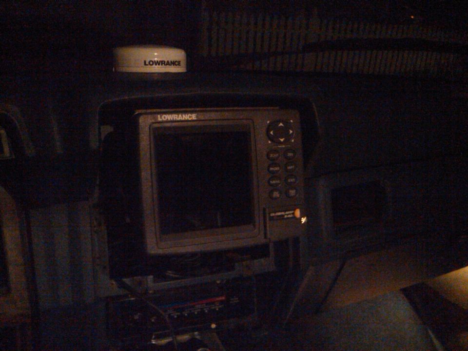 Dashboard with Lowrance GPS and radar unit. Some wiring visible below