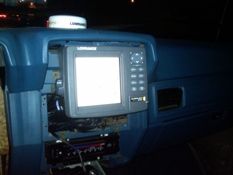 1986 Ford Bronco - Interior view of a 1986 Ford Bronco dashboard, showing a Lowrance GPS unit and stereo.