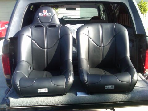 1986 Ford Bronco - Two J Beard racing seats are shown in the bed of a pickup truck.