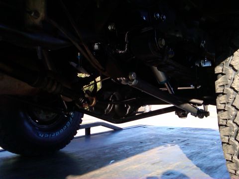 1986 Ford Bronco - Undercarriage view of a vehicle, highlighting suspension components and a BFGoodrich tire. No year is discernible from the image.