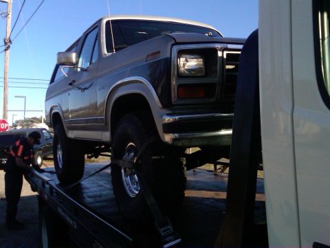 1986 Ford Bronco - This 1986 Ford Bronco is being loaded onto a tow truck.