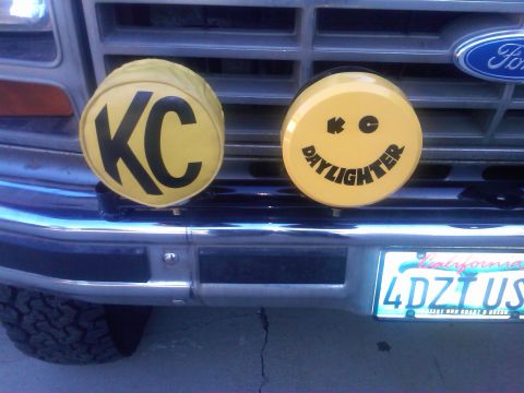 1986 Ford Bronco - This vehicle features KC lights and a smiley face Daylighter light mounted on the front grille.