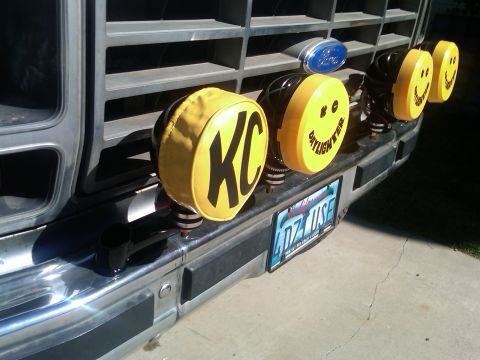 1986 Ford Bronco - Front view of a vintage Ford truck, equipped with KC lights and decorative smiley face lights on the bumper.