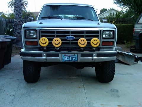 1986 Ford Bronco - Front view of a 1986 Ford Bronco, equipped with four smiley face auxiliary lights.