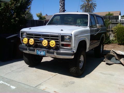 1986 Ford Bronco - This 1986 Ford Bronco features a unique set of four yellow smiley face auxiliary lights mounted on its front grille guard.