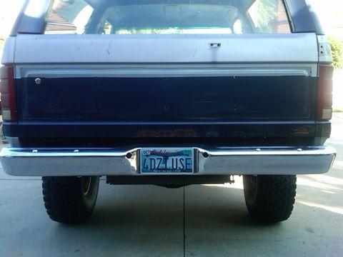 1986 Ford Bronco - Rear view of a 1986 Ford Bronco, showing its tailgate and chrome bumper.