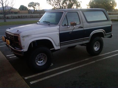 1986 Ford Bronco - This 1986 Ford Bronco features a two-tone paint scheme and is equipped with off-road tires.
