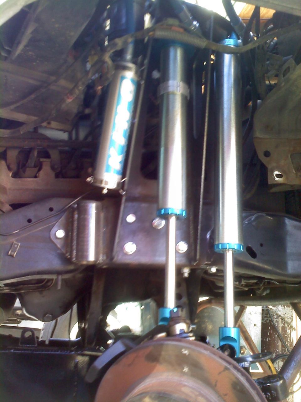 Custom suspension with multiple shock absorbers and blue accents