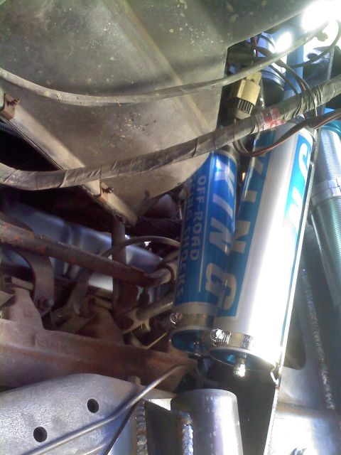 1986 Ford Bronco - Close-up view of King Off-Road shock absorbers, part of a vehicle's suspension system.