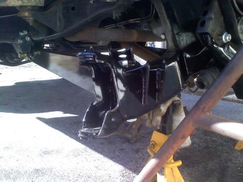 1986 Ford Bronco - The underside of a vehicle shows freshly painted suspension components, indicating recent maintenance or restoration work.