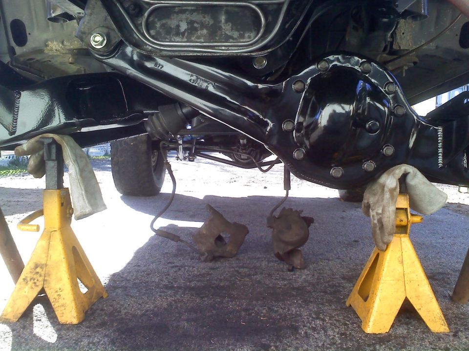 Rear axle assembly on jack stands with brake calipers removed
