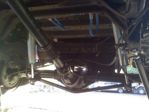 1986 Ford Bronco - The photo shows the undercarriage of a vehicle, focusing on the rear axle and suspension components.