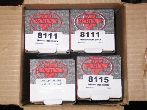 1995 Ford Bronco - Four boxes of Heckethorn Products Premium Hydro Shocks, labeled with part numbers 8111 and 8115, are shown inside a cardboard box.