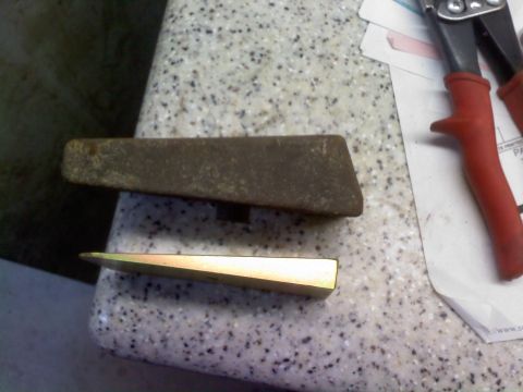 1986 Ford Bronco - A pair of wedges and a pair of tin snips are placed on a speckled countertop.