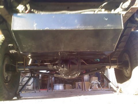 1986 Ford Bronco - Undercarriage view reveals an auxiliary fuel tank installation above the rear axle and leaf springs.