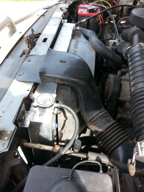 1992 Ford Bronco - Engine bay view focusing on the radiator and associated hoses and components.