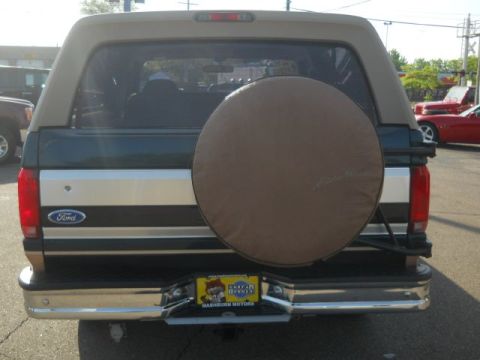 1994 Ford Bronco - Rear view of a 1994 Ford Bronco, showing the spare tire and Ford badging.