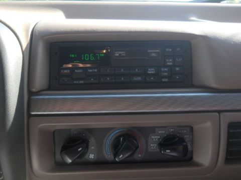 1994 Ford Bronco - Interior view of a 1994 Ford Bronco, focusing on the dashboard's radio and climate control unit.