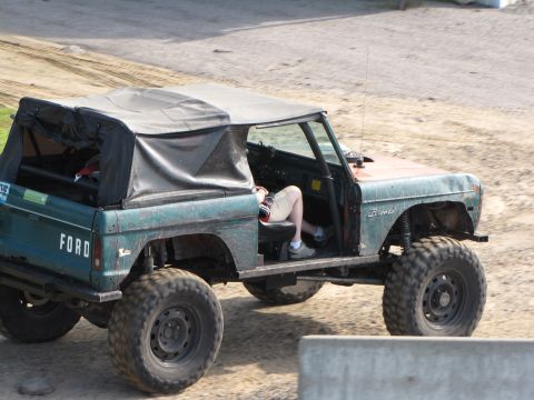 1979 Ford Bronco - This 1979 Ford Bronco, seen from the side, features a soft top and oversized tires, suggesting off-road modifications.
