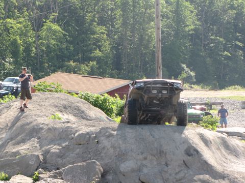 1979 Ford Bronco - An off-road buggy navigates a rocky incline during an outdoor event.