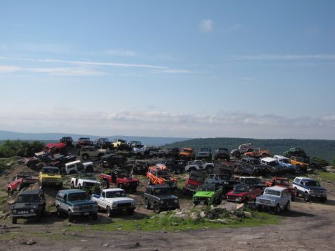 1979 Ford Bronco - A large gathering of Ford Broncos and other SUVs parked on a rocky hillside.