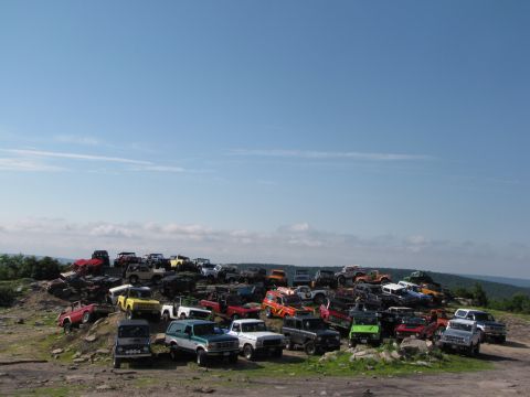 1979 Ford Bronco - A large gathering of off-road vehicles parked on a hillside.