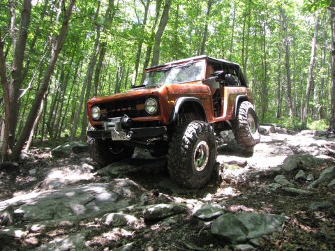 1979 Ford Bronco - This 1979 Ford Bronco is shown off-roading through a rocky, wooded area.