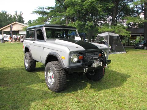 1979 Ford Bronco - A modified 1978 Ford Bronco with off-road tires and a winch is displayed outdoors.