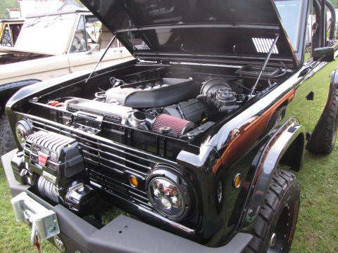 1979 Ford Bronco - Customized black Ford Bronco with its hood up, revealing the engine bay and a front winch.