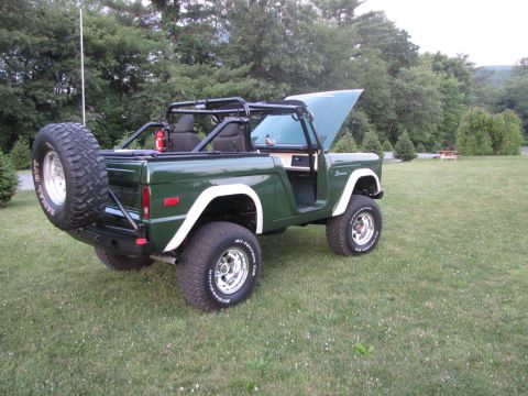 1979 Ford Bronco - This 1979 Ford Bronco is shown with its hood up and a spare tire mounted on the rear.