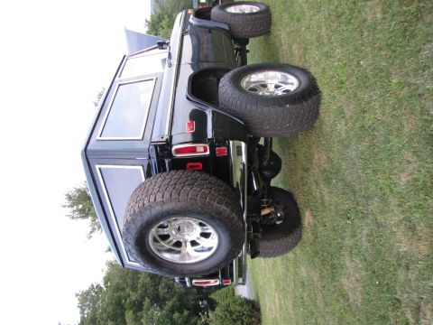 1979 Ford Bronco - This black 1979 Ford Bronco features a rear-mounted spare tire and large aftermarket wheels.