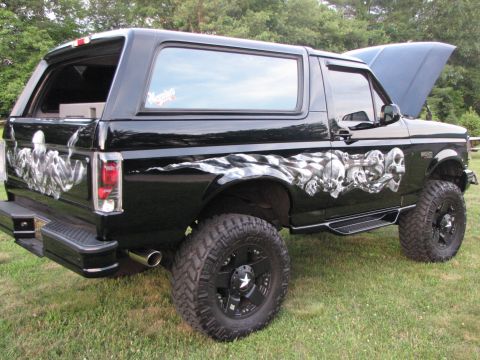 1979 Ford Bronco - This modified Ford Bronco features custom skull graphics along its side and a lifted suspension.