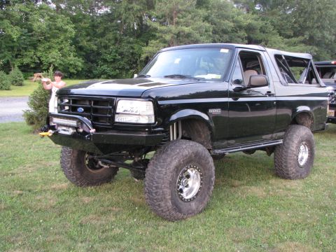 1979 Ford Bronco - This lifted black Ford Bronco features a custom front bumper with a winch and large off-road tires.