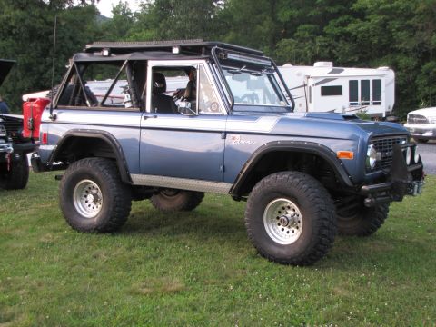 1979 Ford Bronco - This blue 1979 Ford Bronco features a roll cage, off-road tires, and a custom front bumper.