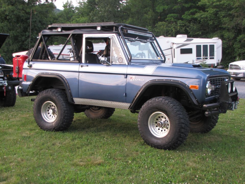Blue 1979 Ford Bronco with off-road tires and roll cage