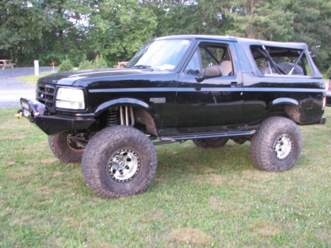1979 Ford Bronco - This modified SUV features large off-road tires, an aftermarket bumper, and a visible roll cage.