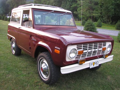 1979 Ford Bronco - This maroon Ford Bronco, likely a 1978 model, is shown from a three-quarter front angle on a grassy lawn.