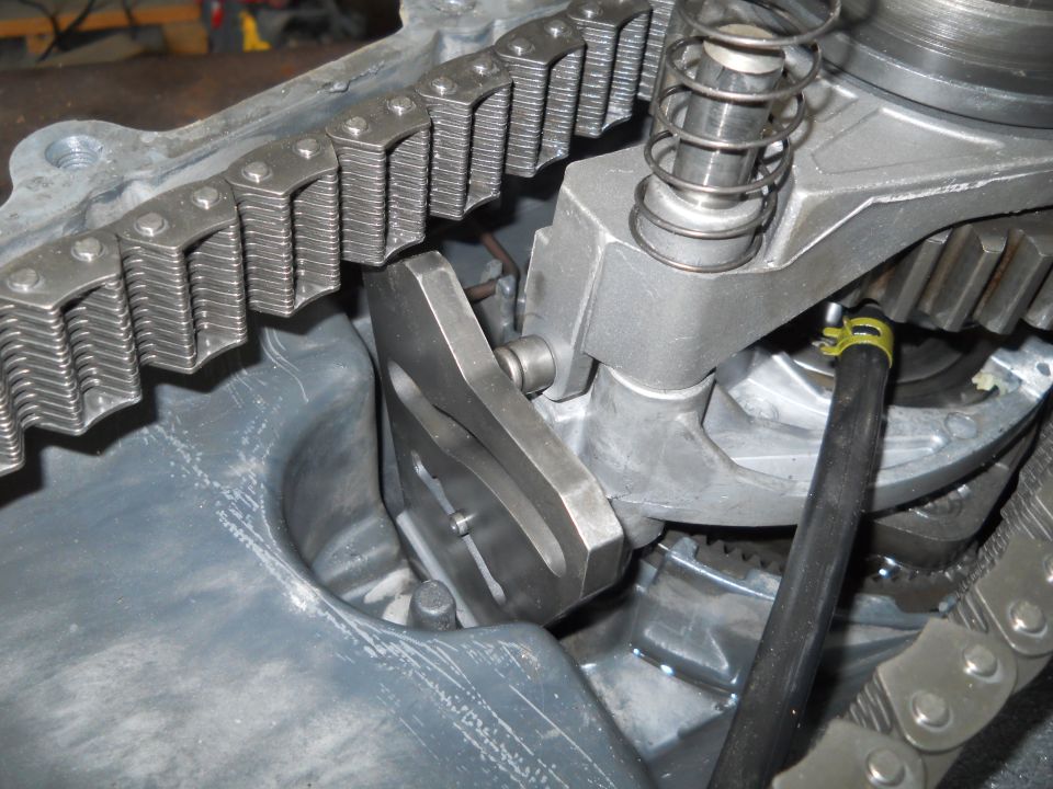 Transfer case chain and gears with a spring-loaded mechanism