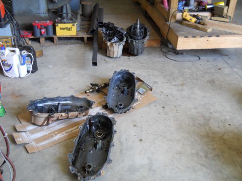1992 Ford Bronco - Transfer cases and components laid out for inspection or repair in a workshop setting.