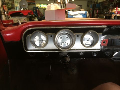 1964 Ford Fairlane - Interior view of a 1964 Ford Fairlane dashboard, three circular gauges and red exterior paint.