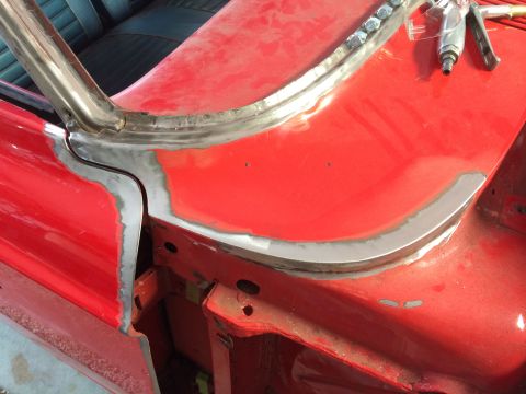 1964 Ford Fairlane - Metalwork and primer are visible on a car's body during repair work around the windshield.
