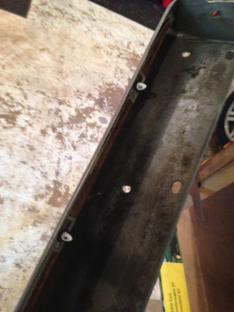 1990 Geo Storm GSi - Car part with mounting hardware visible, placed on a workbench.